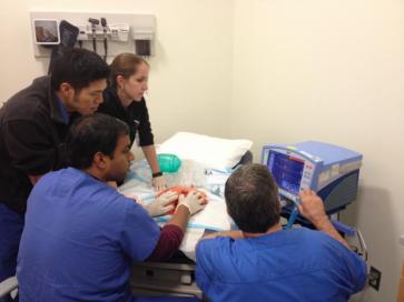 Four medical students looking at monitor