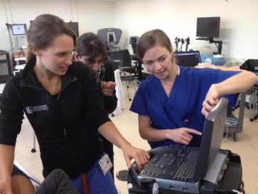 Three medical students looking at computer