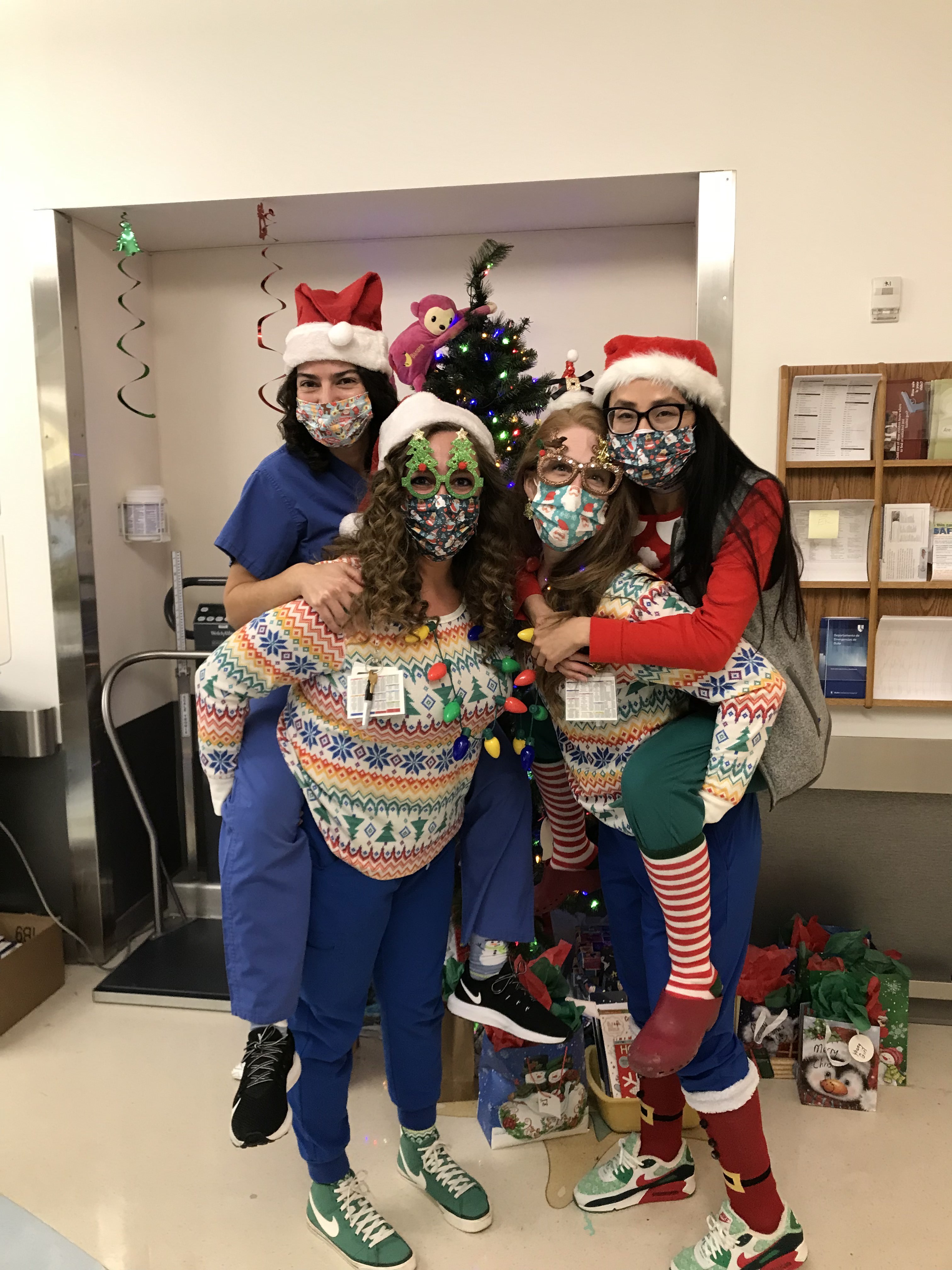 Doctors in holiday sweaters and hats
