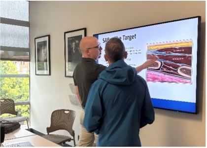 Two people looking at a screen