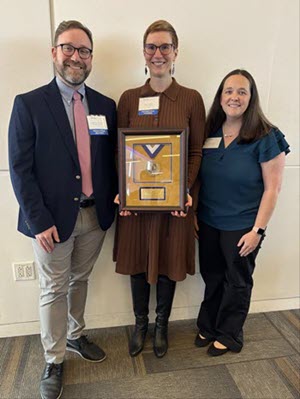 Matthew McCartt, PA-C, MPAS, MPH, Erin Hanlin, MD, MPH, and Crystal Crider, posing with the award