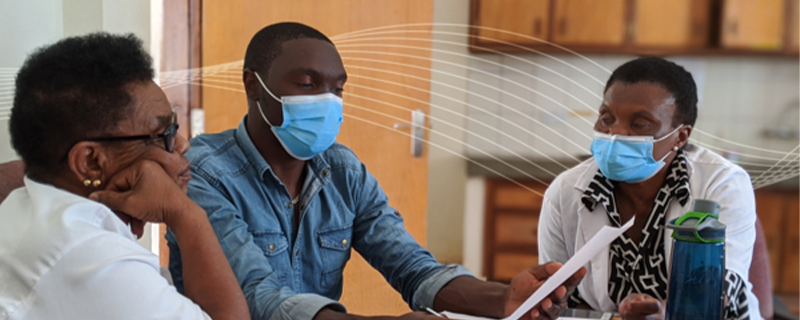 healthcare providers in ppe consulting with a patient