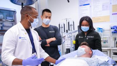 Duke EM physicians consult with a patient