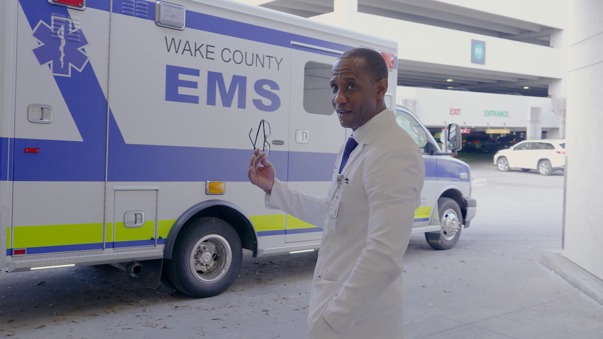 Dr. Randolph in front of a Wake County EMS vehicle