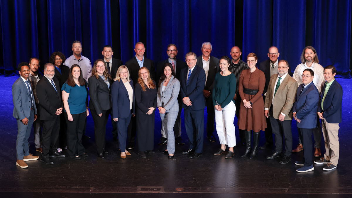 Emergency Medicine flood response team on stage for a group photo with president Price