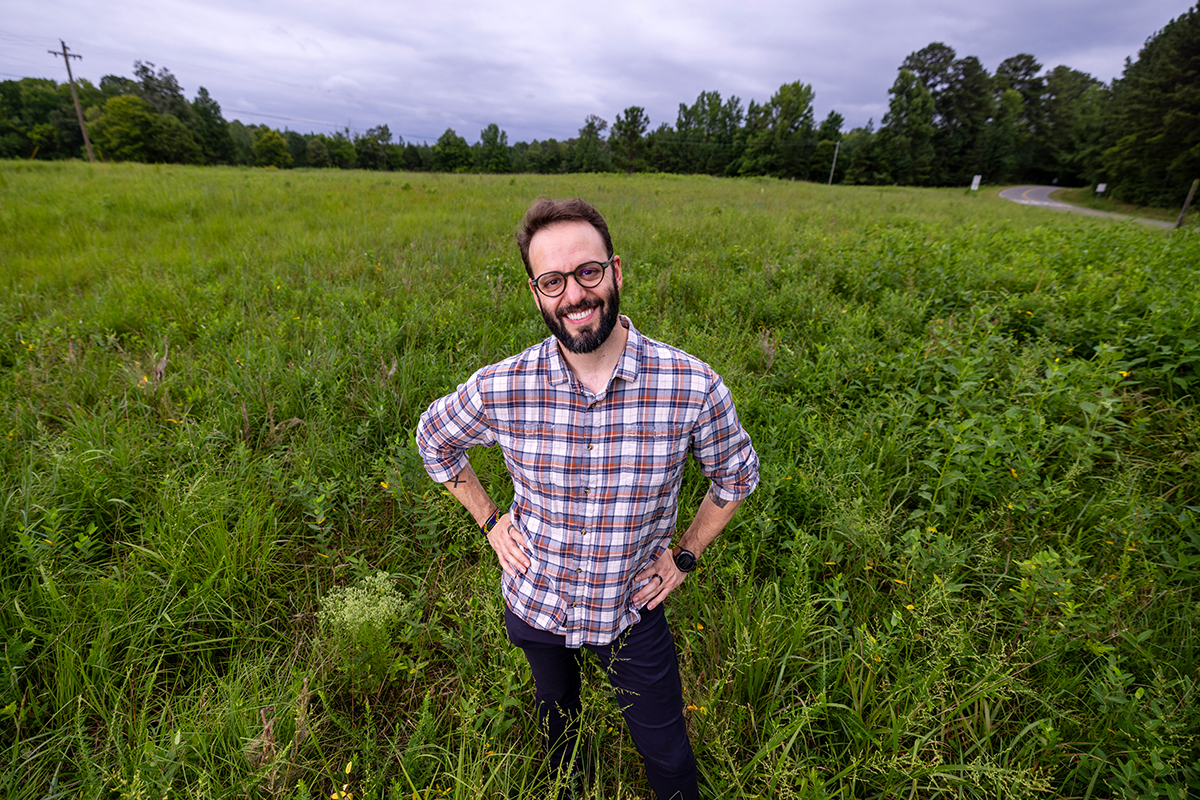 João Ricardo Nickenig Vissoci, PhD, standing in a rural field