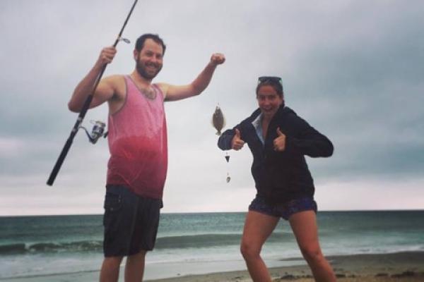 Two people fishing on the beach