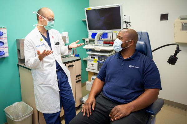 Physician and patient communicate in an exam room