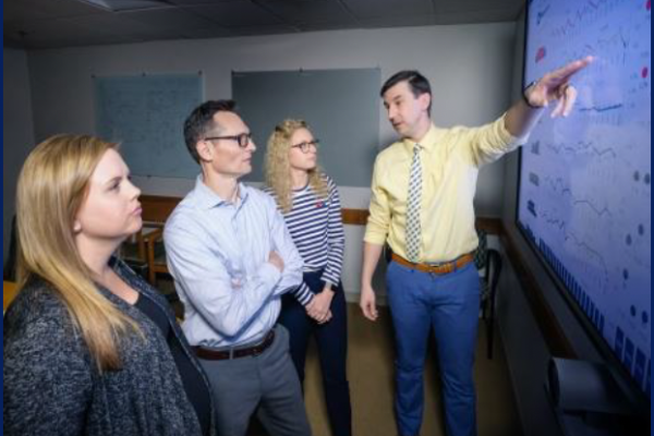 Emergency Services Director Dr. Jason Theiling reviews dashboard of current Duke University Hospital Emergency Department operational data