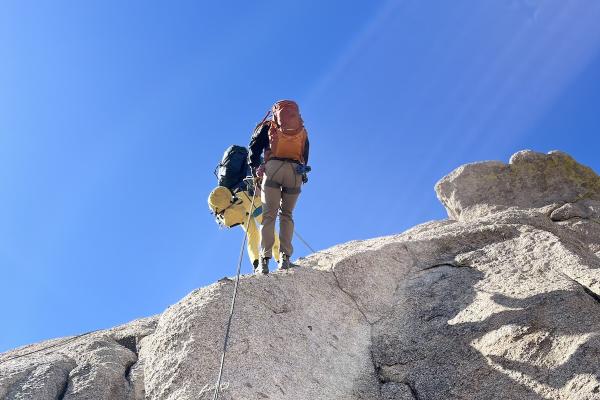 Two people rock climbing