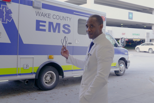 Dr. Randolph in front of a Wake County EMS vehicle