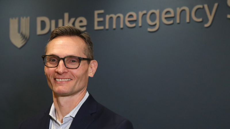 Dr. Charles Gerardo stands in front of the Duke Emergency Medicine sign