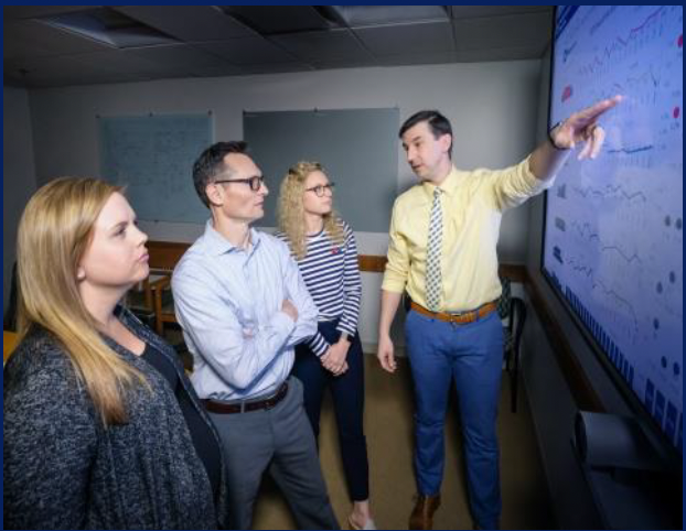 Emergency Services Director Dr. Jason Theiling reviews dashboard of current Duke University Hospital Emergency Department operational data