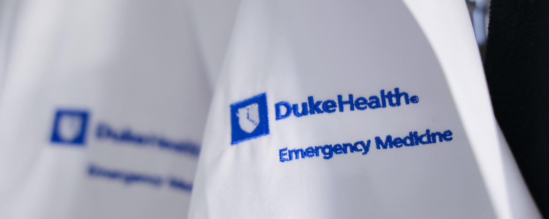 Close up of Duke EM white coat logo