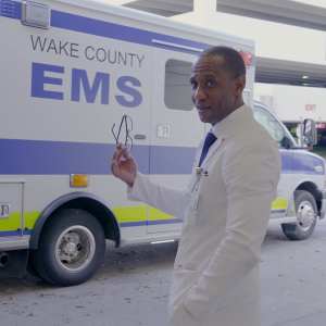 Dr. Randolph in front of a Wake County EMS vehicle